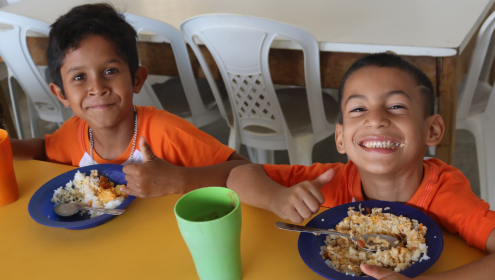 Duas crianças praticando a alimentação saudável